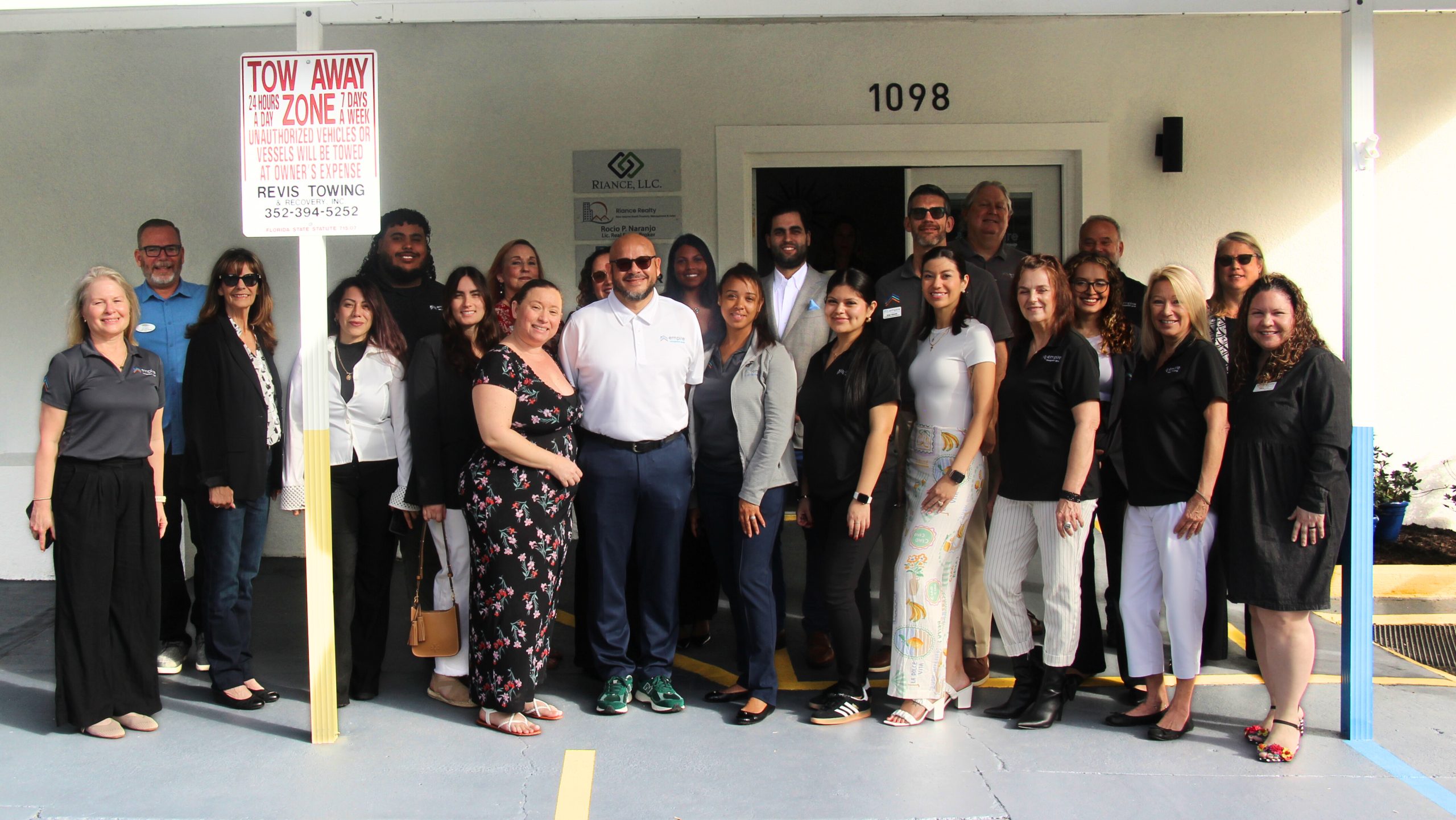 Empire Management Group team standing together outside a managed property in Florida, showcasing HOA and condo association management professionals
