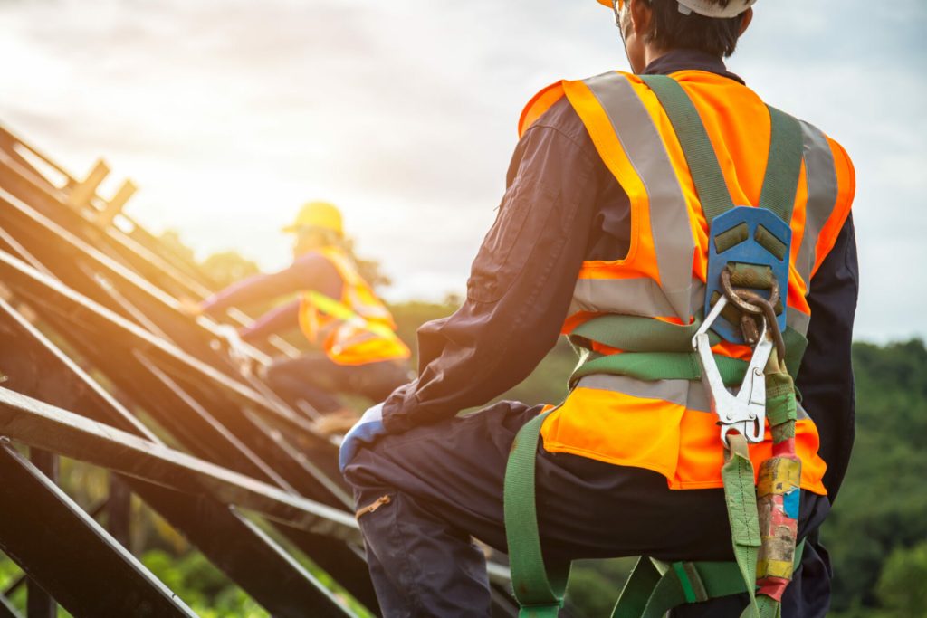 Construction workers in safety harnesses and high-visibility vests working on a sloped roof under bright sunlight, representing professional vendor services. Accompanying text emphasizes Empire Management Group’s commitment to vendor partnerships and compliance.