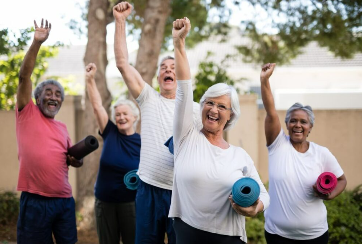 Group of senior citizens with their fist in the air ready to exercise