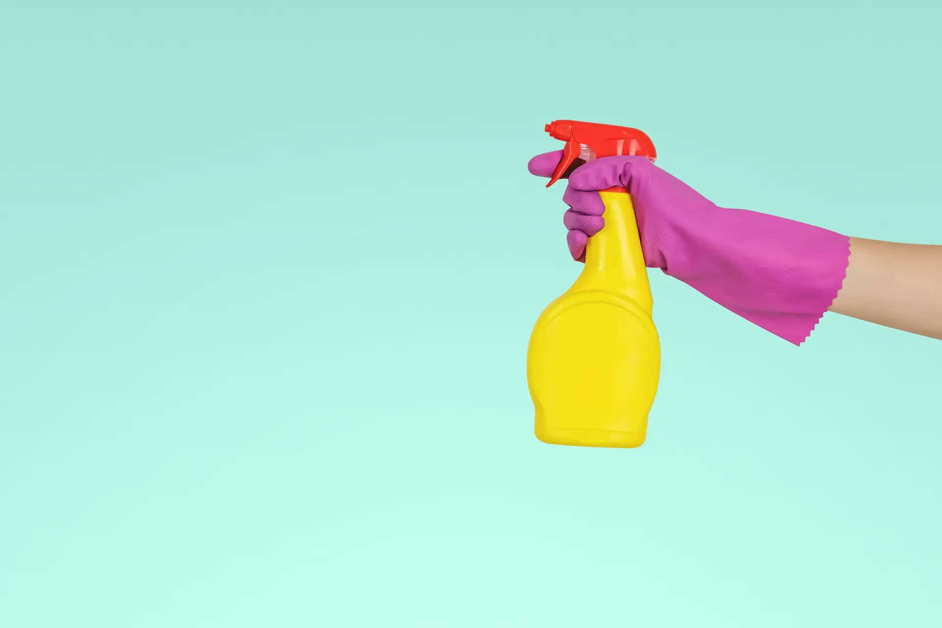 a hand with a cleaning bottle