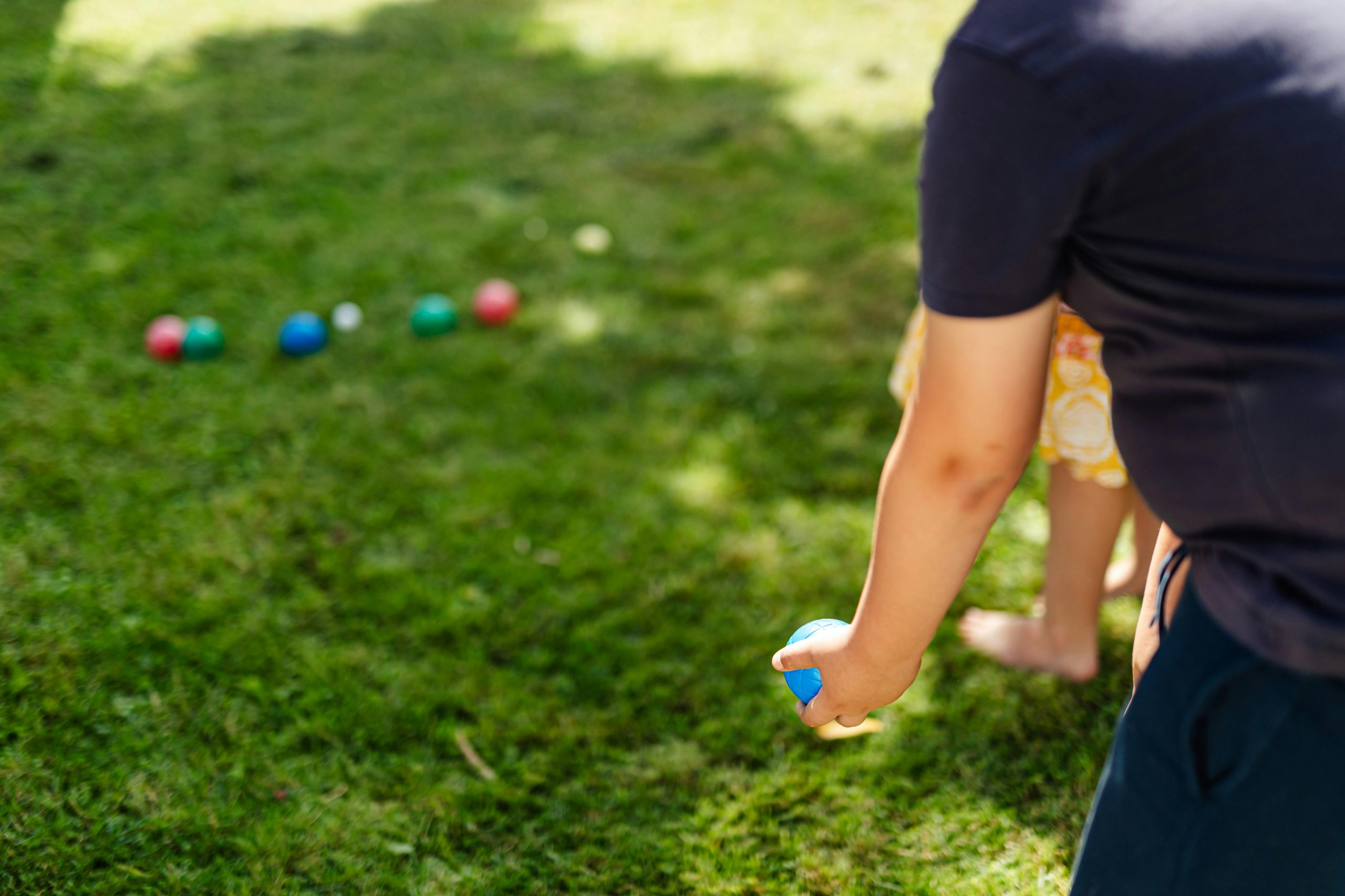 Residents enjoying outdoor lawn games in a Florida HOA or condo community with lifestyle amenities featured in Community by Empire magazine.